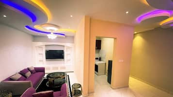 Family Studio, City View | Living area | Flat-screen TV