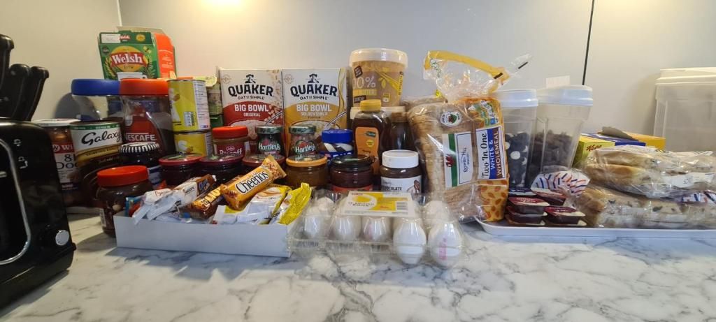 A kitchen counter with various food items and kitchen appliances.