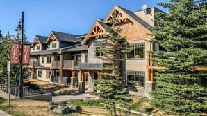A hotel with a modern architectural style, featuring a stone facade and wooden accents.