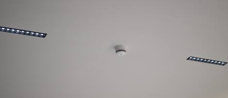 A ceiling with three recessed lighting fixtures.