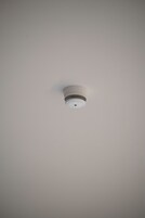 A ceiling-mounted smoke detector.