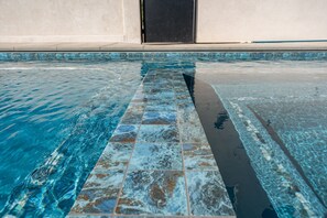 Enjoy a refreshing swim in this inviting pool, surrounded by a colorful tile border.