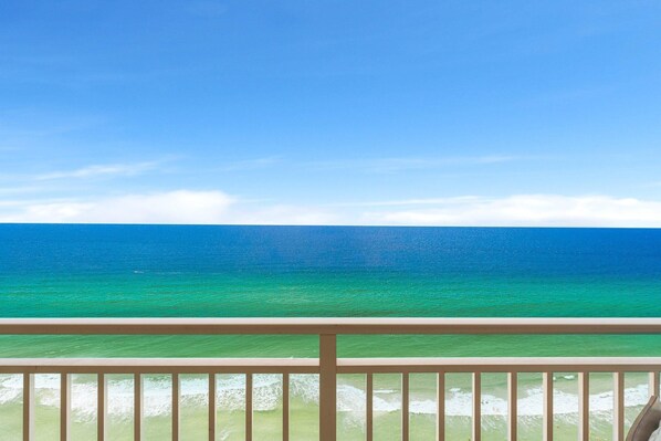 A balcony with a view of the ocean.