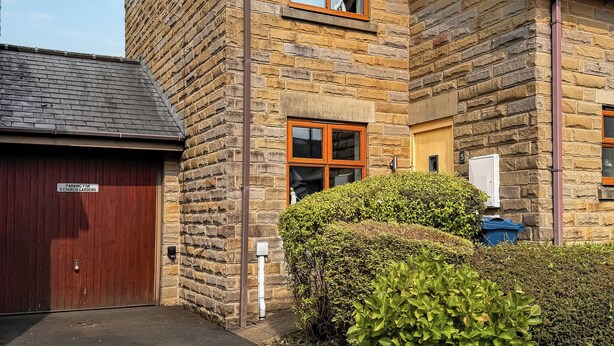 A stone building with a garage door, a window, and a mailbox. - 2 bedroom accommodation in Longridge (Longridge)