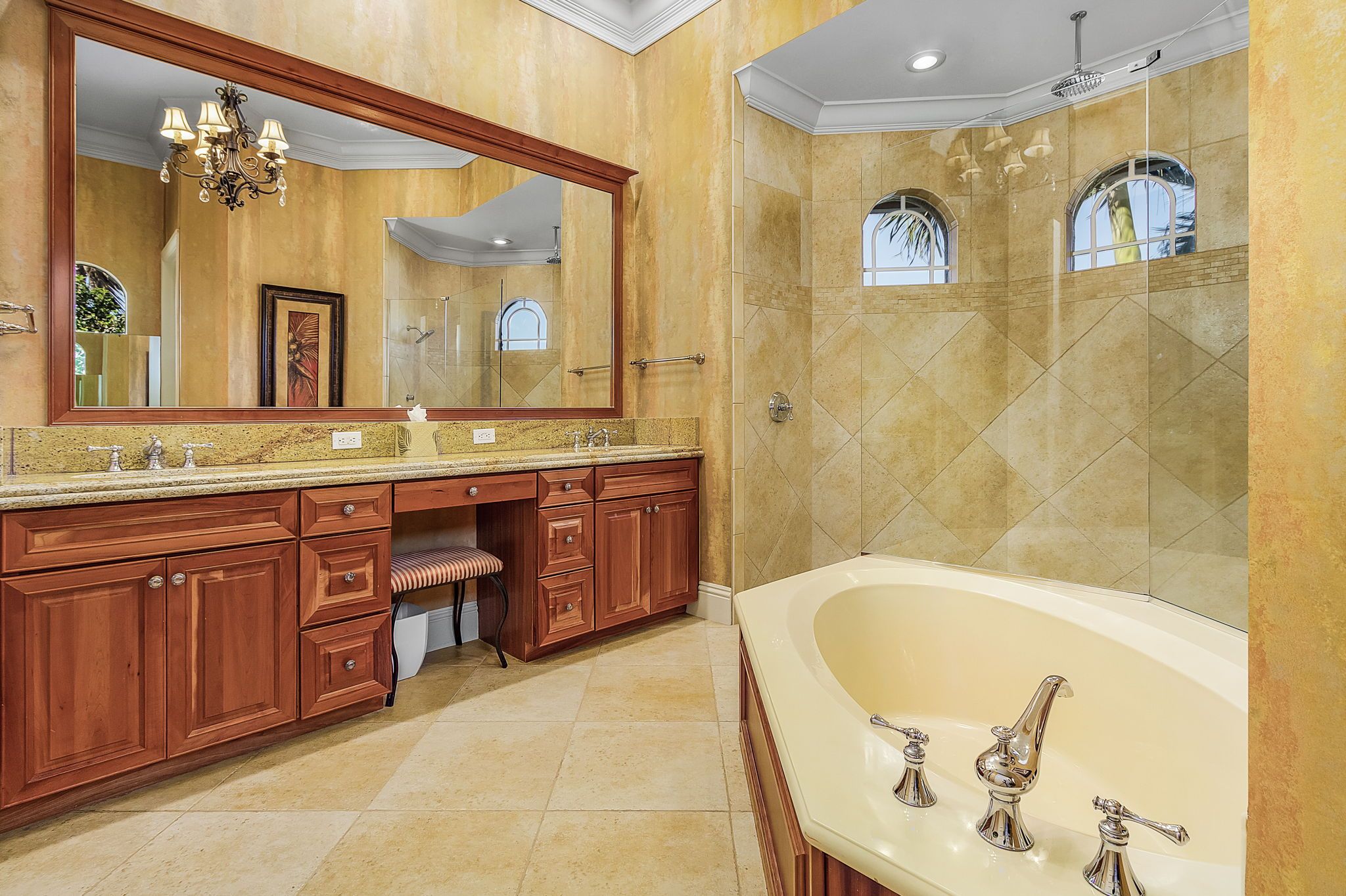 A spacious bathroom with a large bathtub, a walk-in shower, and a vanity with a mirror.