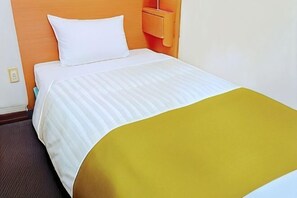 A hotel room with a bed, a nightstand, and a wall-mounted shelf. - Urban Hotel Tokyo Fuchu East Exit (Fuchu)