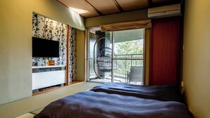 A hotel room with a bed, a TV, a sliding door to a balcony, and a wall-mounted air conditioner. - YuYu Hakone - Private Open Air Onsen Usage Guaranteed (Hakone)