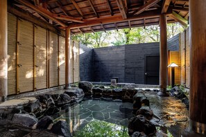 A traditional Japanese garden with a stone pond, wooden structures, and a view of trees. - YuYu Hakone - Private Open Air Onsen Usage Guaranteed (Hakone)