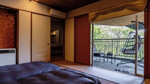 A hotel room with a bed, a sliding door leading to a balcony with chairs and a table, and an air conditioning unit. - YuYu Hakone - Private Open Air Onsen Usage Guaranteed (Hakone)