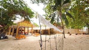A beachside restaurant named 'Slumber Party Koh Phangan' with outdoor seating and a thatched roof. - Slumber Party Koh Phangan Beach (Ko Pha-ngan)