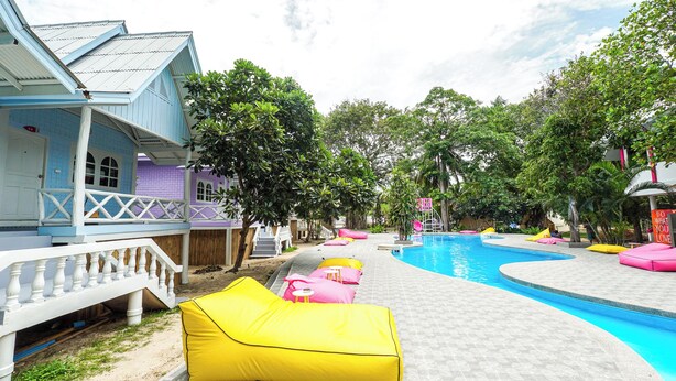 A pool area with colorful lounge chairs and a clear blue pool. - Slumber Party Koh Phangan Beach (Ko Pha-ngan)