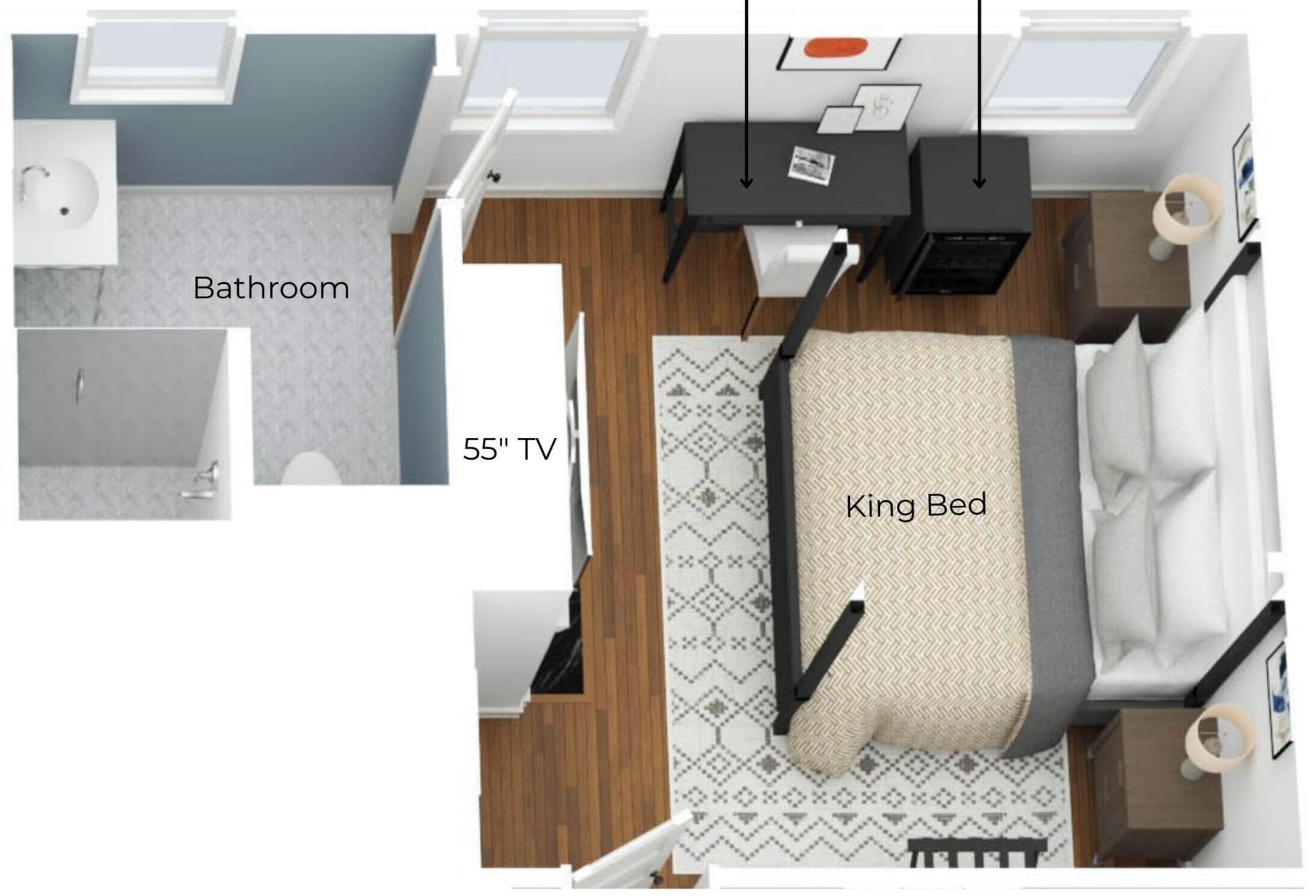 A bedroom with a king bed, a 55' TV, a bathroom, and a desk with a chair.