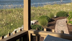 A view of a lake with a bell tower and a statue, surrounded by a wooden deck and a paved path. - Miele di North Myrtle Beach — 1st Floor, 2BR-2BA Condo @ Inlet Point Villas (North Myrtle Beach, SC)