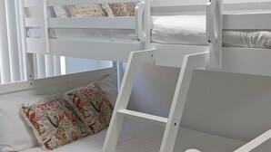 A bunk bed with a lower bunk and a pull-out desk. - Marine Parade - Ocean Views - Unit 6 (The Entrance)