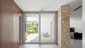 A modern interior with a sliding glass door leading to a patio area.