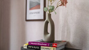 A vase with flowers on a stack of books. - Creative Corner: Stylish Apt. in Ghent's Heart (Gent)