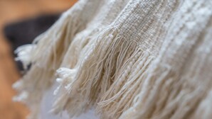 A close-up of a textured fabric with fringe details. - Creative Corner: Stylish Apt. in Ghent's Heart (Gent)