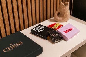 A table with a chess book, a box of chocolates, and a Talkzie box.