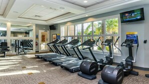 A fitness center with treadmills, ellipticals, and weight machines. - Game Room, Pool & Mickey-Themed Retreat (Davenport)