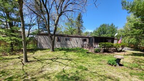 A house with a porch, a small garden, and an American flag.