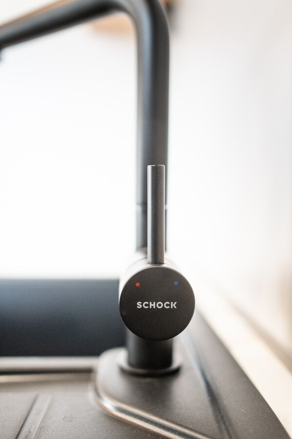 A black SCHOCK device on a metallic surface.