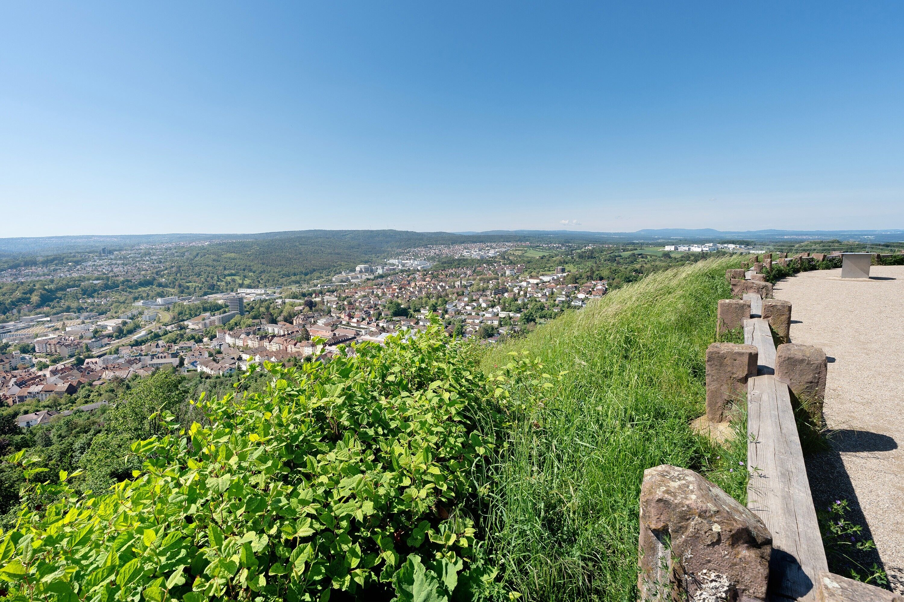 A high vantage point overlooking a town with a clear sky.