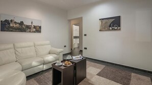 A modern living room with a sofa, coffee table, and artwork on the walls. - Quiet City Apartment Dexa, Rijeka, Croatia (Rijeka)