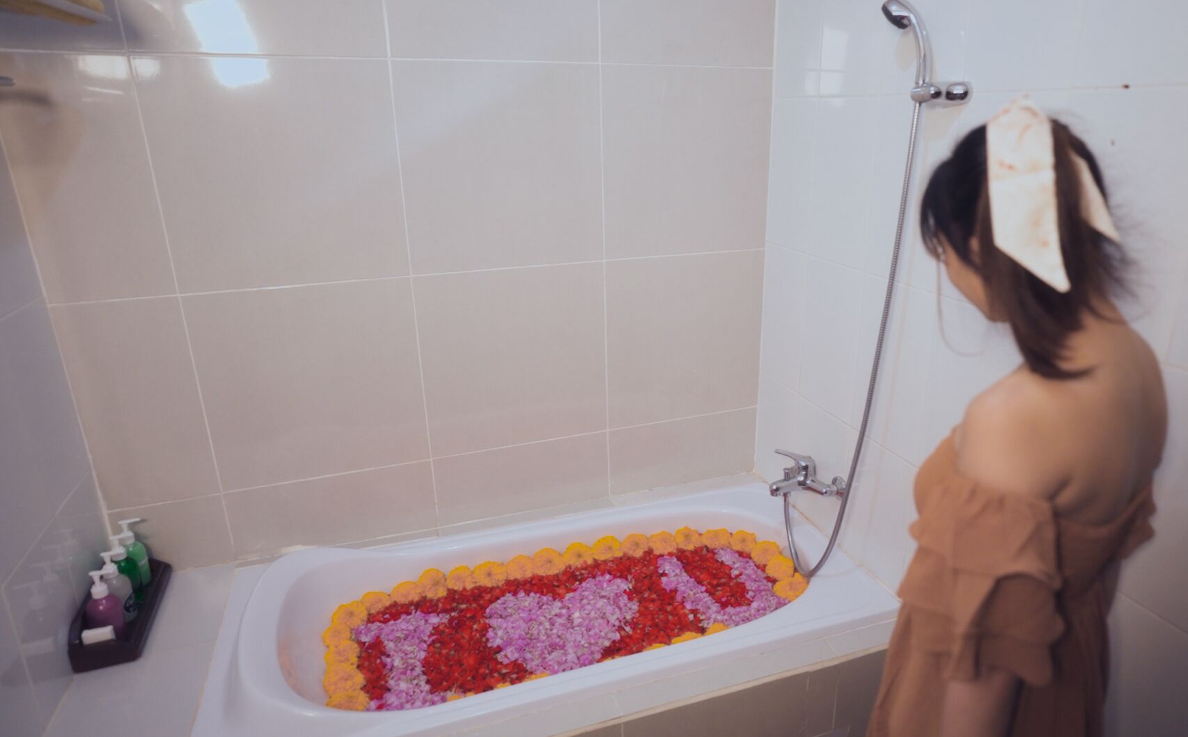 A bathtub filled with colorful flower petals.
