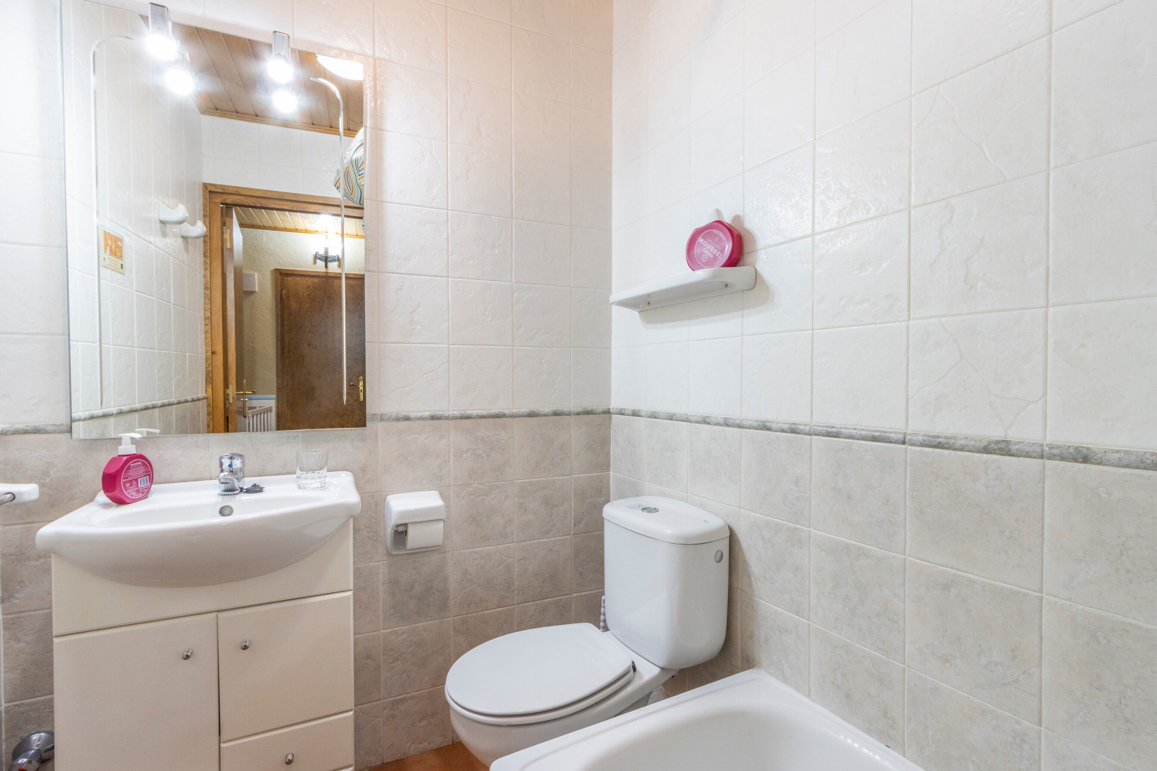 A bathroom with a sink, toilet, and bathtub.