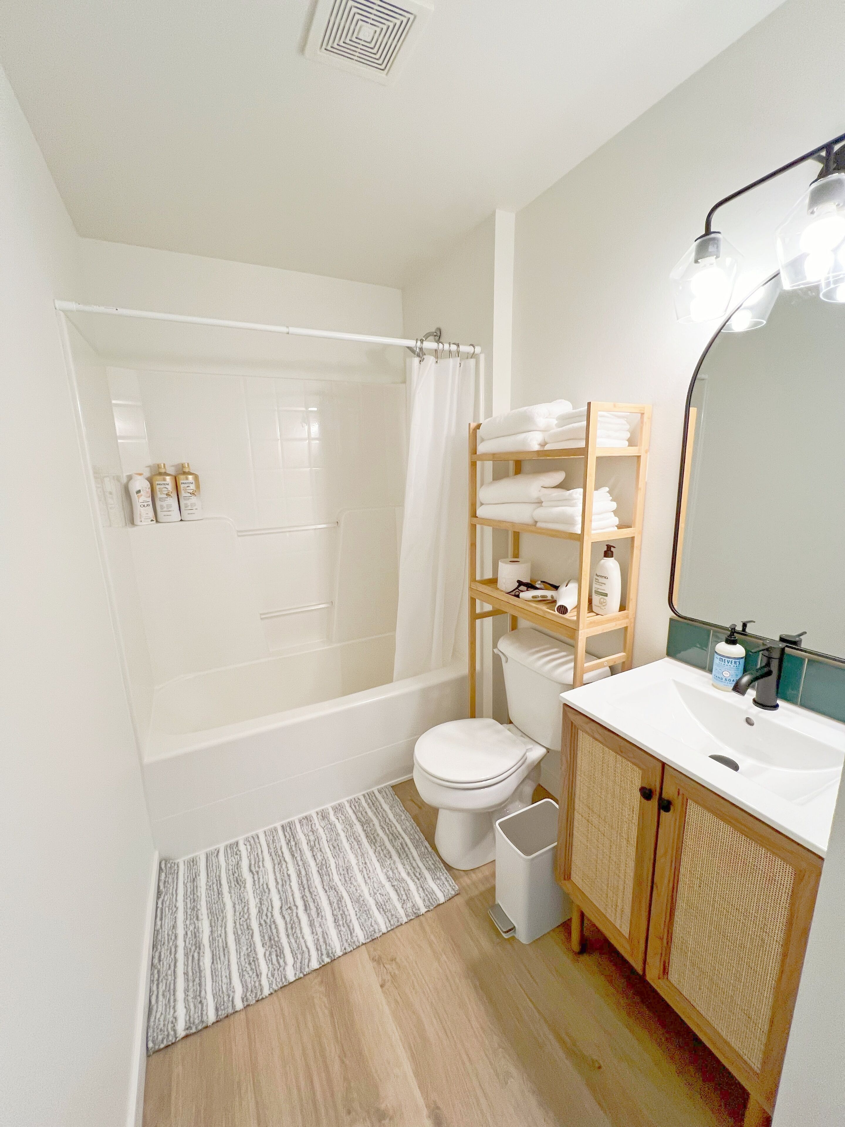 A modern bathroom with a bathtub, toilet, and sink.