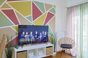 Appartamento Premium, cucina, vista città | Area soggiorno | Smart TV 65 pollici con canali digitali, Netflix, servizi in streaming