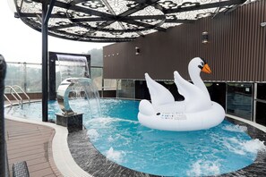 A hot tub with a swan float, a waterfall feature, and a covered seating area. - Thai Ha Boutique Hotel (Bai Chay)