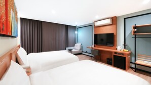 A hotel room with two beds, a desk with a chair, a TV, and a small seating area with a bench. - Sun lake Hotel (Yuchi)