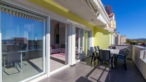 A modern apartment with a balcony, sliding glass doors, and a dining area. - Villa Ava (Sibenik)