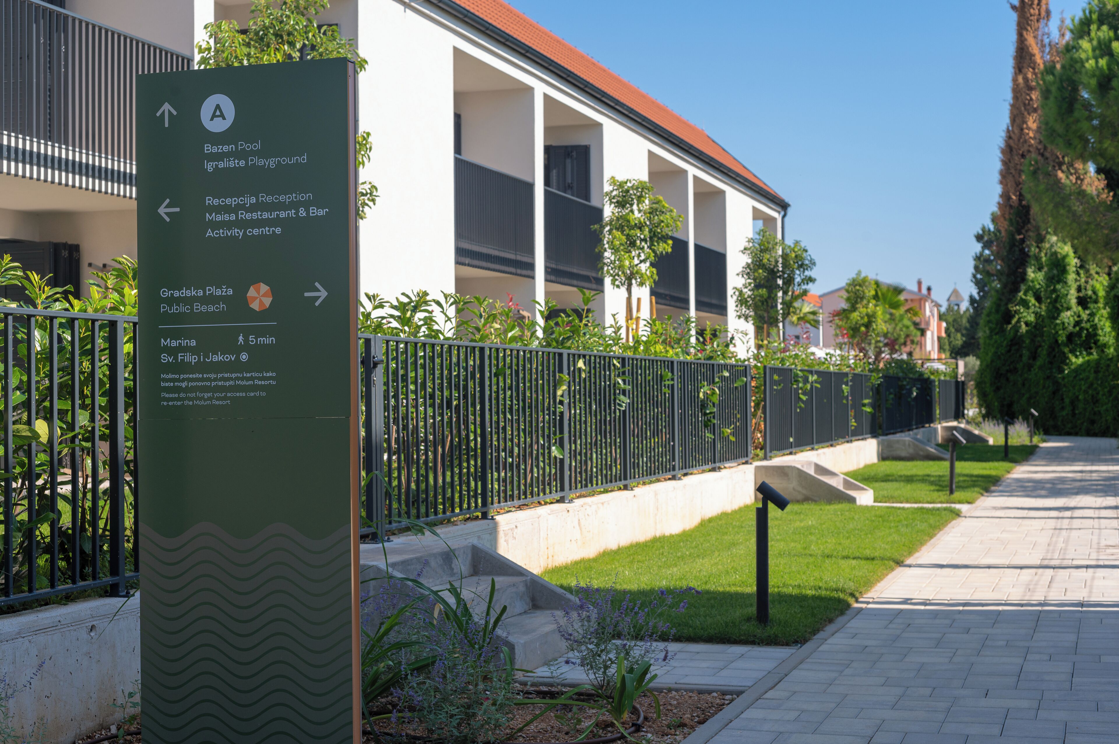 A directional sign with arrows pointing to various amenities such as a pool, restaurant, and activity center.