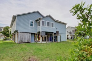 A two-story house with a front porch, a garage, and a small backyard. - Seaing is Believing | Surf City, NC | 4 Bedrooms | Short Walk to Beach (Surf City)