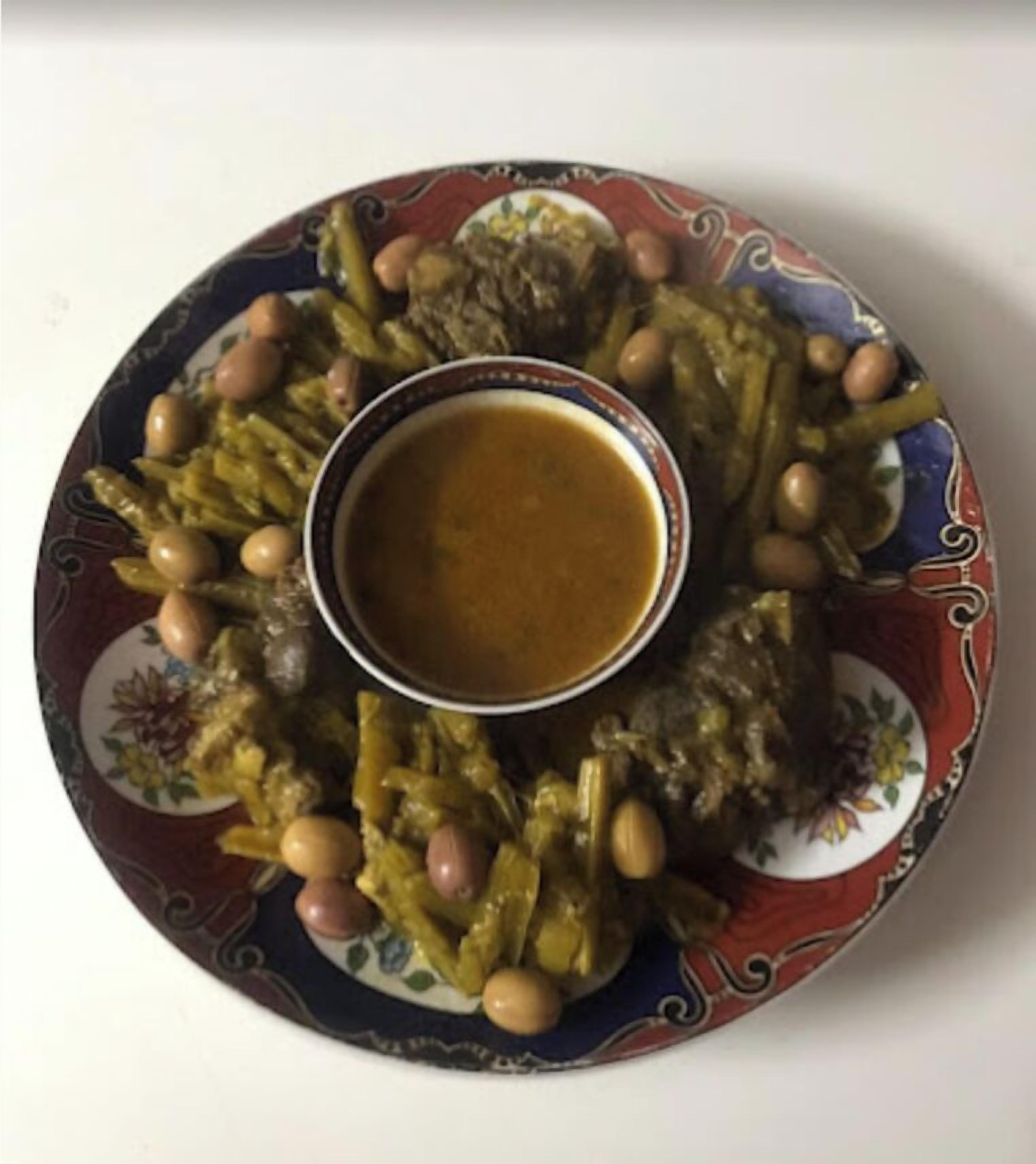 A plate of food with a bowl of sauce in the center.