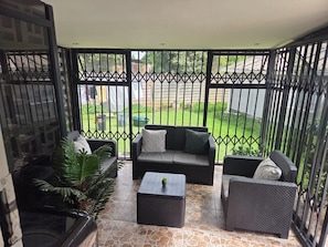 A balcony with a sofa, two armchairs, and a coffee table. - Casamaya Avondale- Charming 3 Bedroom House (Harare)