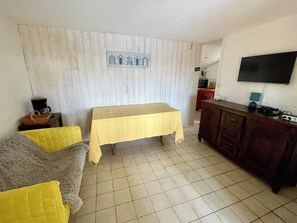 A room with a bed, a sofa, a table, a TV, and a cabinet. - Small bay view house in 1st line - Mimbeau A0392 (Lège-Cap-Ferret)