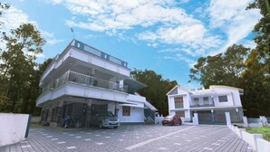 A modern two-story house with a covered driveway and a car parked in front.