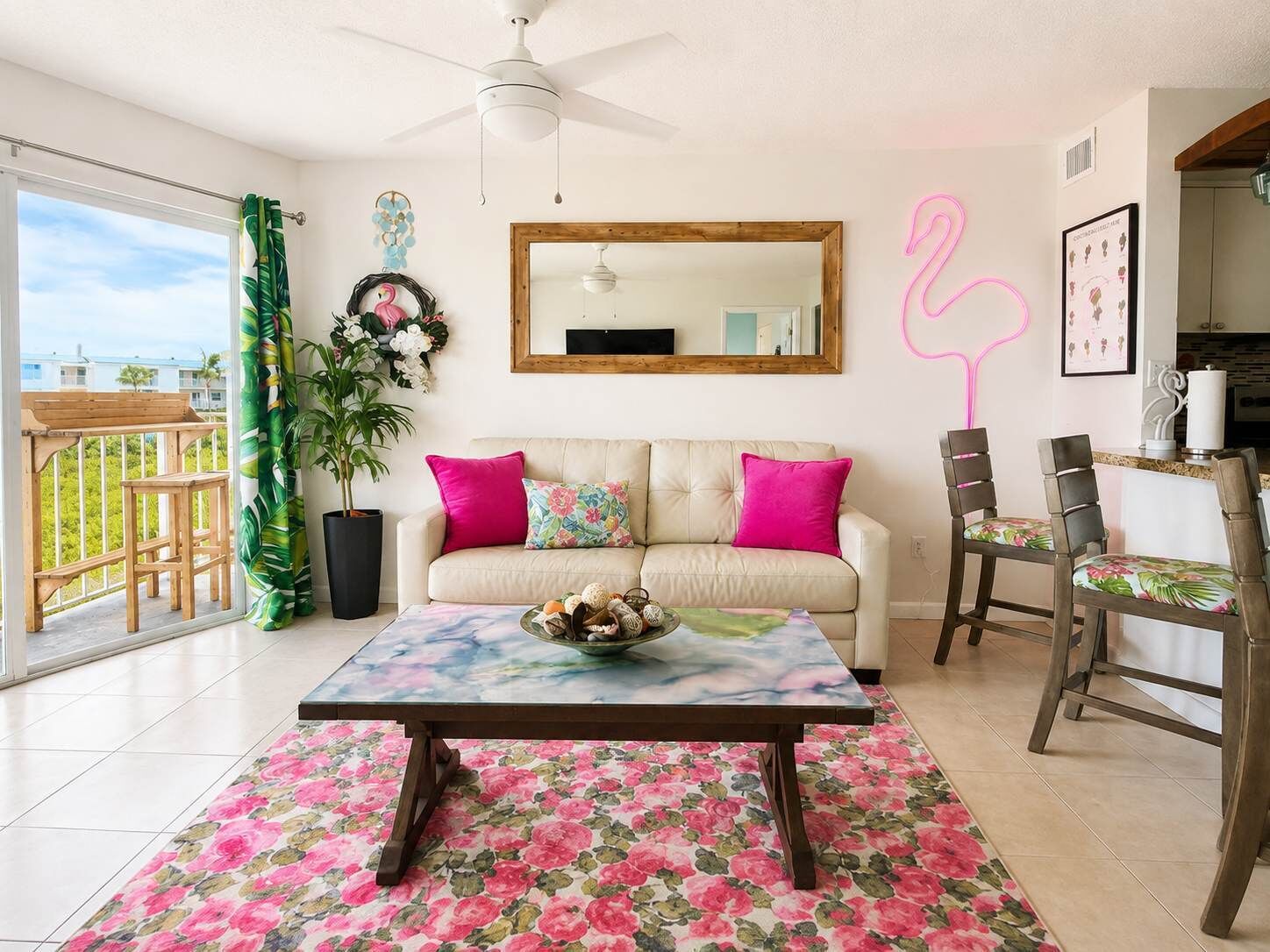 A living room with a sofa, a coffee table, and a dining area with chairs.