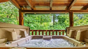 A hot tub with a wooden deck and a view of a forest. - 2BR Resort Cabin w/Hot Tub + Fireplace + Privacy! (Sevierville)