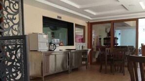 A spacious living area with a kitchen, dining table, and chairs. - HAVEN STAY HOTEL (Eldoret)