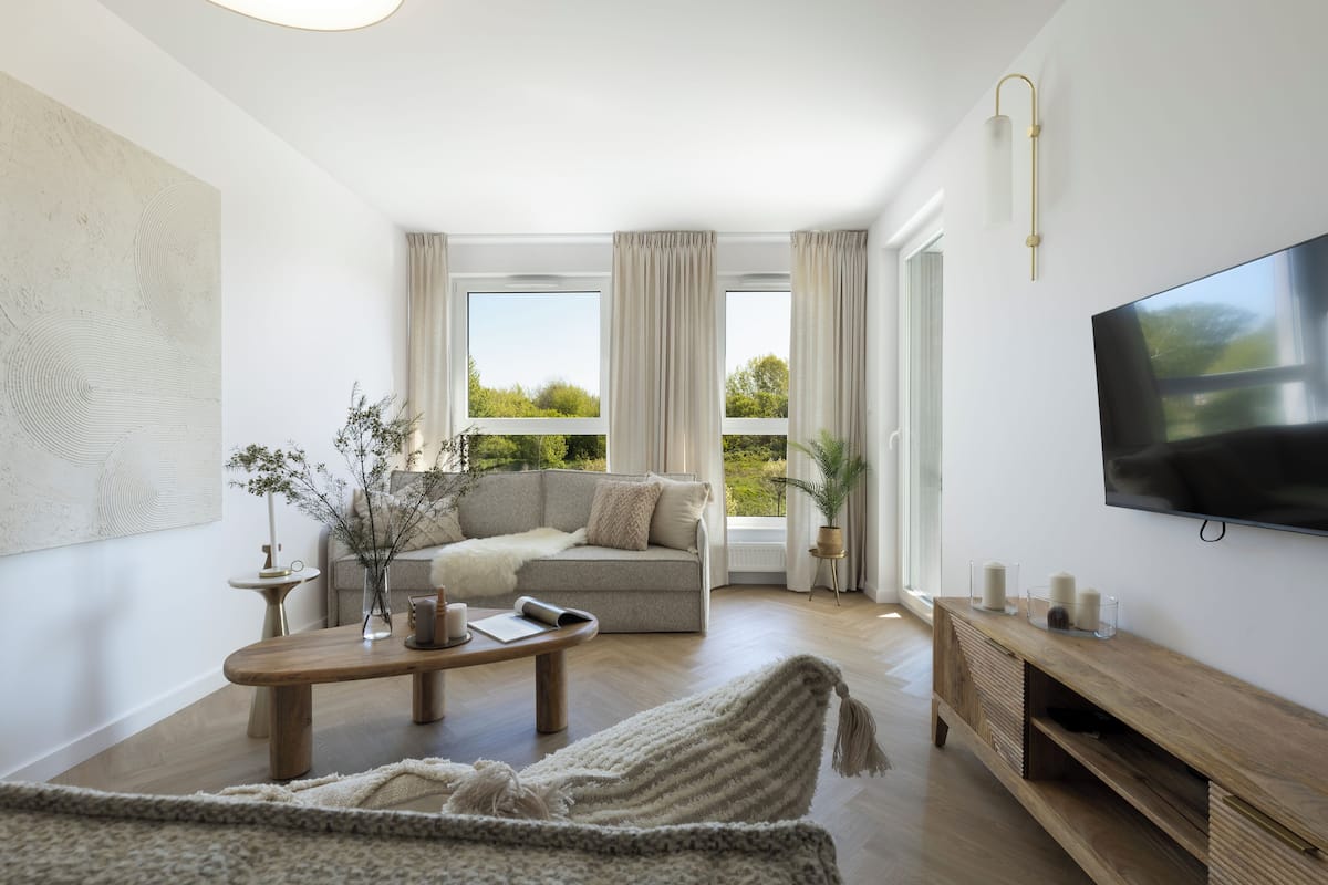 A modern living room with a sofa, coffee table, and TV.