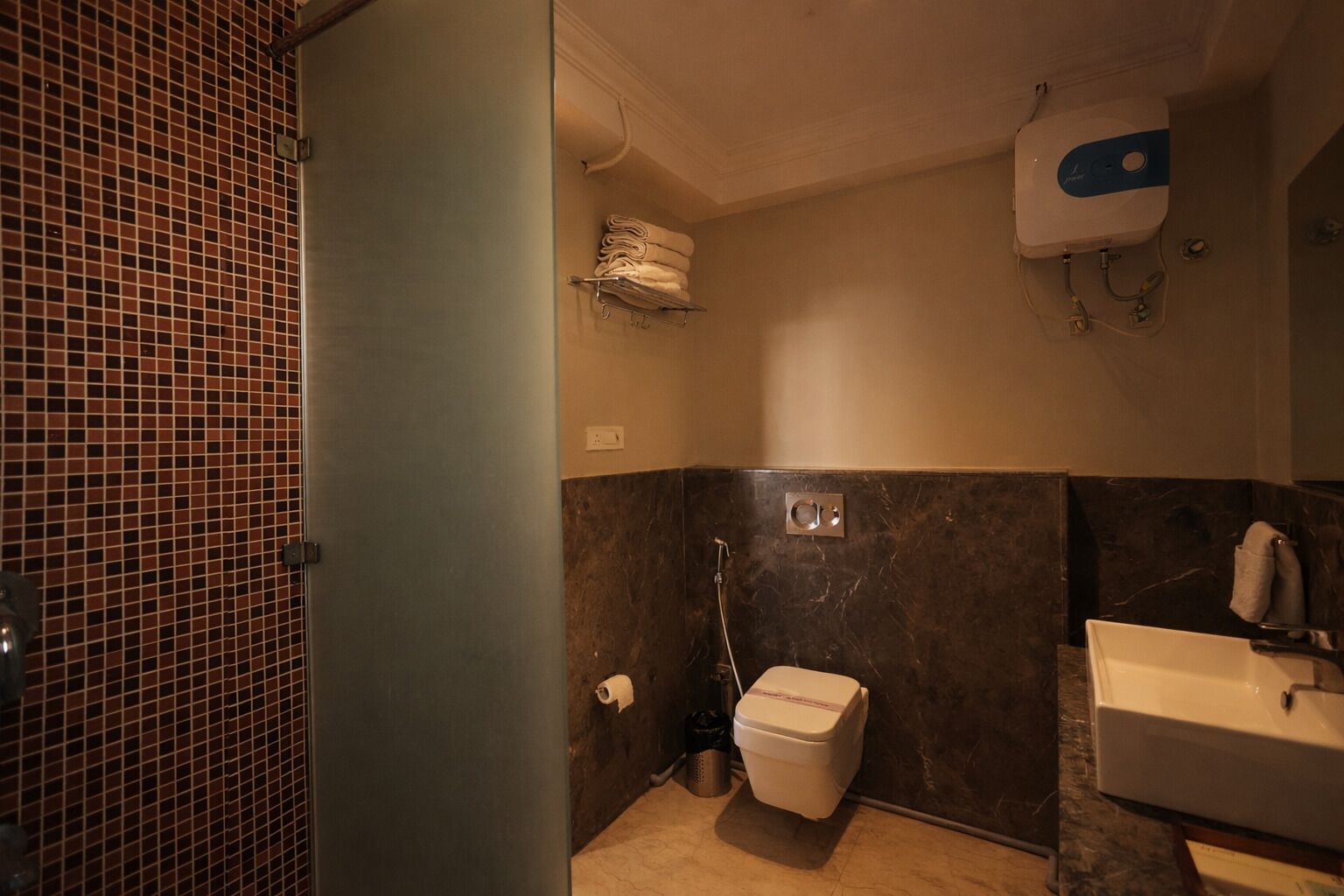 A bathroom with a toilet, sink, and shower.