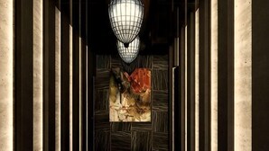 A hallway with a patterned floor, a large abstract painting on the wall, and a hanging light fixture.