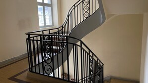 A spiral staircase with black railings and a handrail, leading to an upper floor. - 2 Bedroom Apartment in Saint-Malo (Saint-Malo)