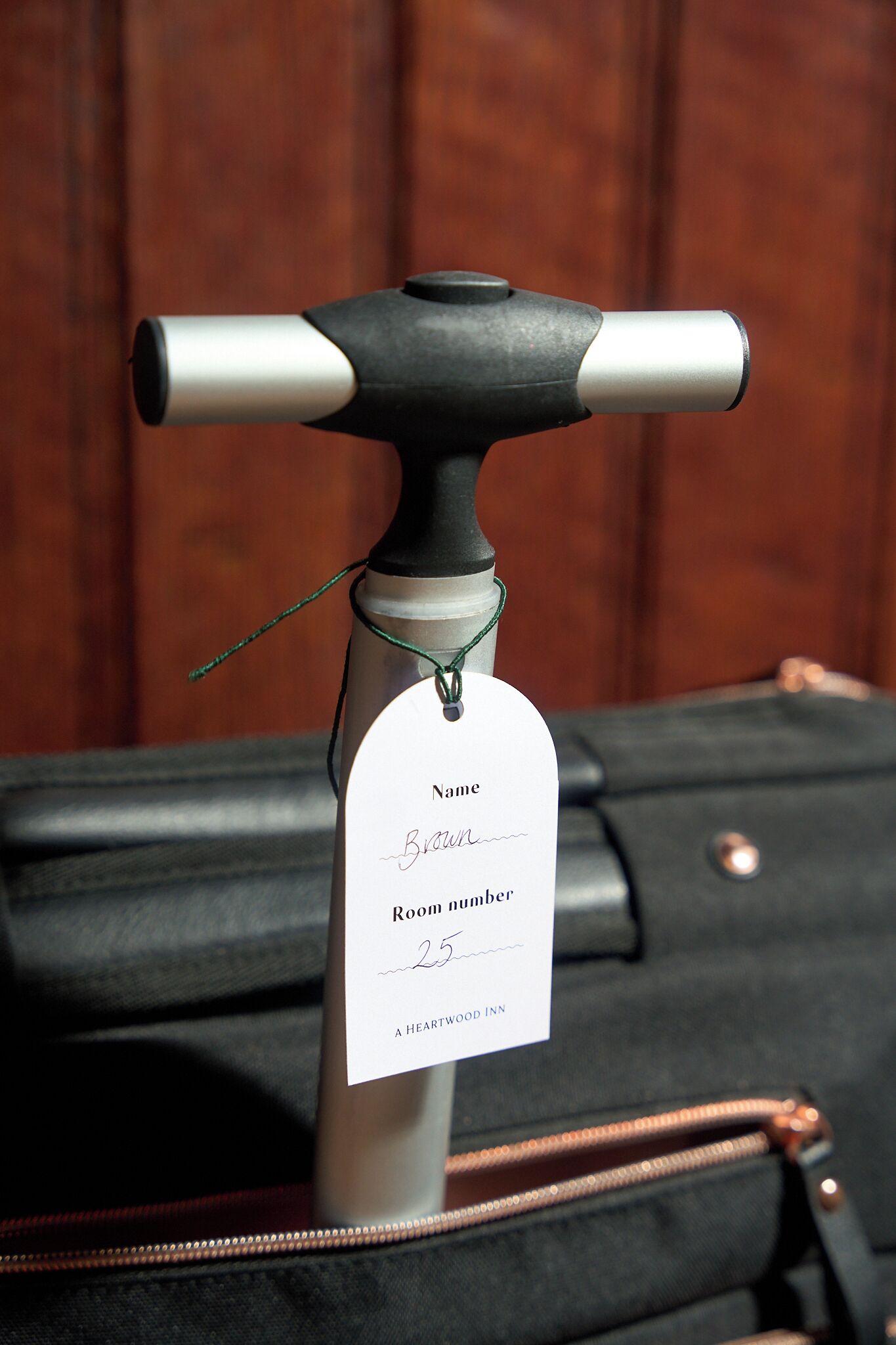 A luggage trolley with a tag attached to it.
