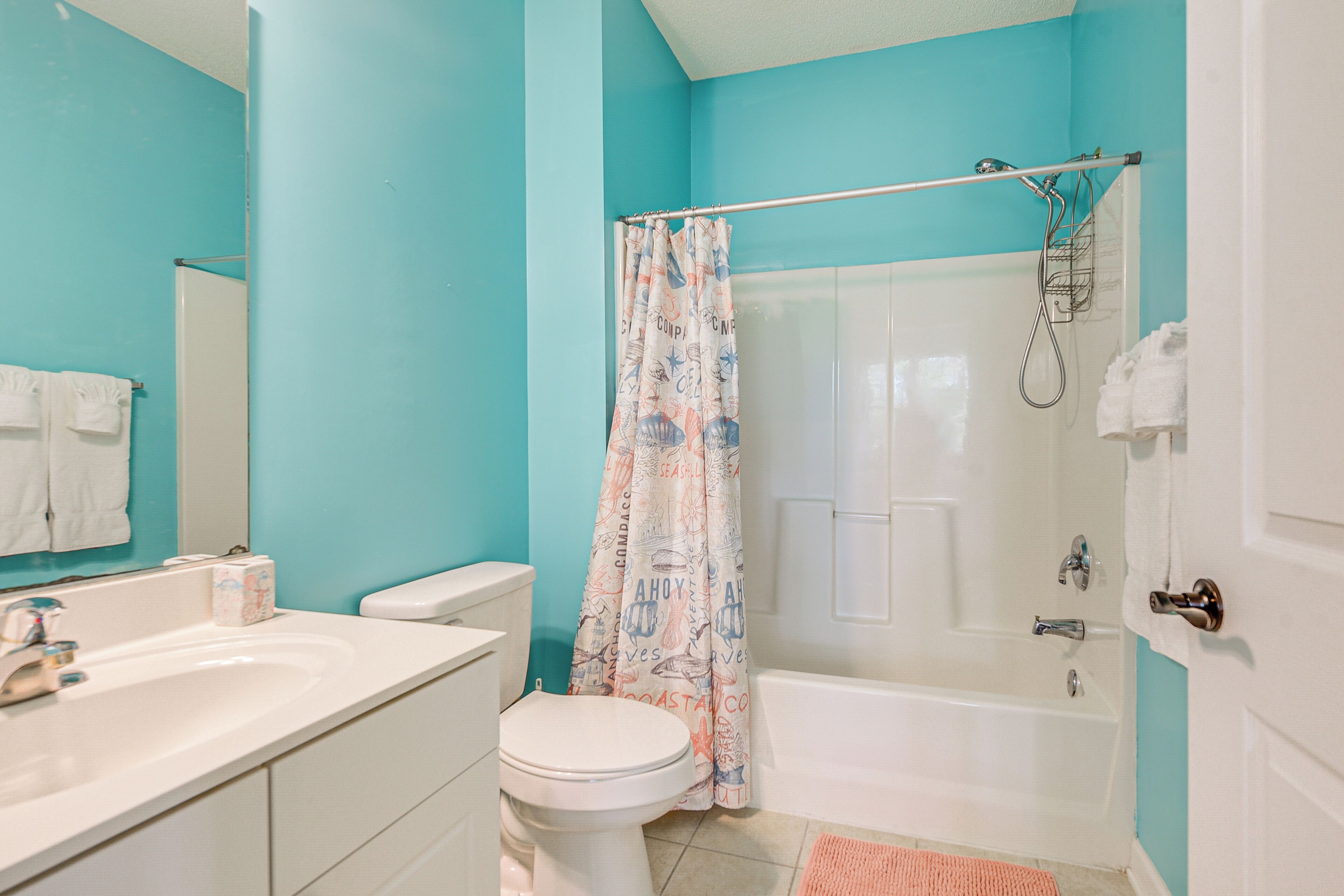 A bathroom with a white toilet, a sink, and a bathtub.