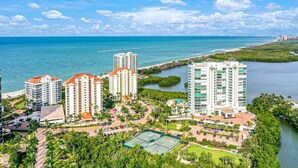 A coastal hotel complex with multiple high-rise buildings, a tennis court, and a marina. - Panoramic Gulf Views, Newly Renovated, Spectacular Sunsets in Naples (Naples)